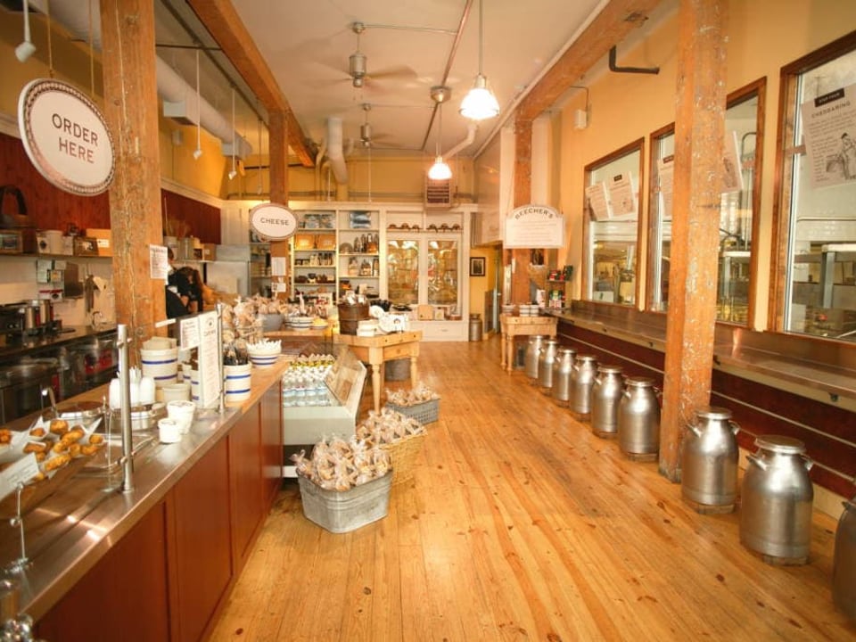 Beecher's Pike Place cheese shop interior with glass-walled production kitchen
