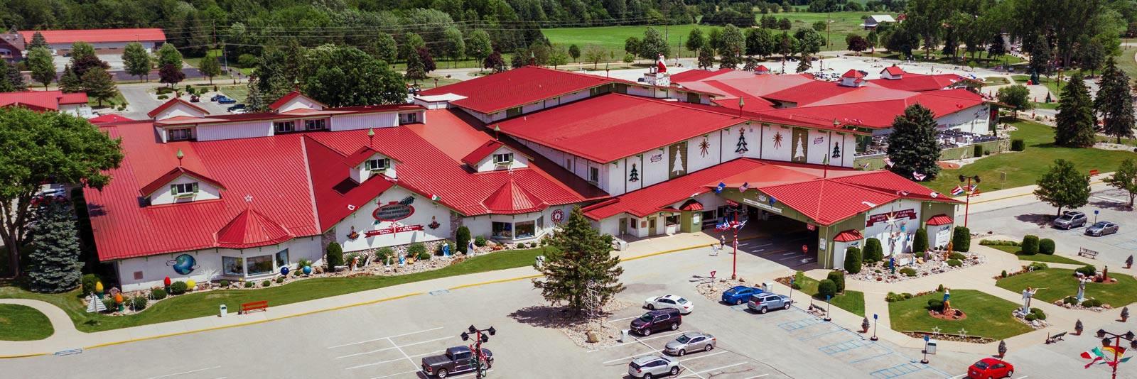 Wide aerial view of Bronner's CHRISTmas Wonderland in Frankenmuth showing the enormous decorated store complex and parking areas