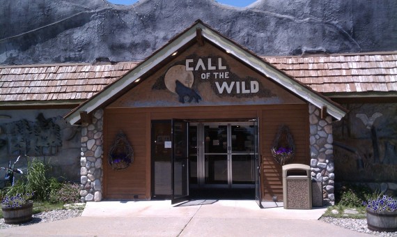 Call of the Wild Museum entrance in Gaylord with the stone façade, wildlife sign and carved animal figures visible