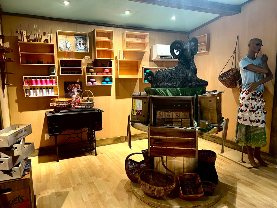 Wooden shelves and artisan displays inside Chulita Hill Farm and Creamery’s Farm Store