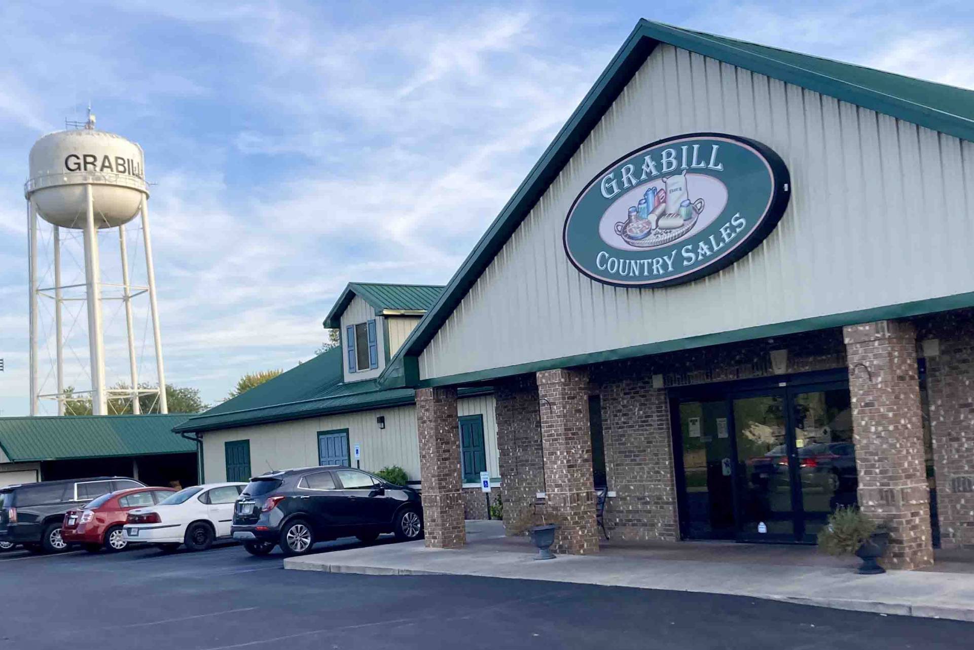 Grabill Country Sales storefront and sign beside the Grabill water tower