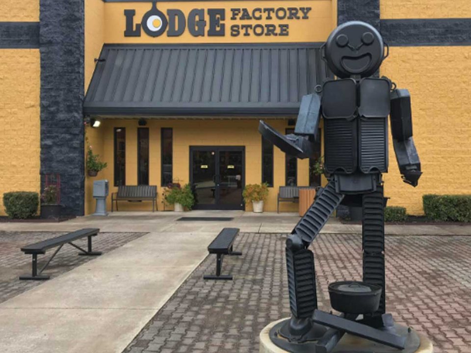 South Pittsburg Lodge Factory Store entrance and Pan Man cast-iron sculpture