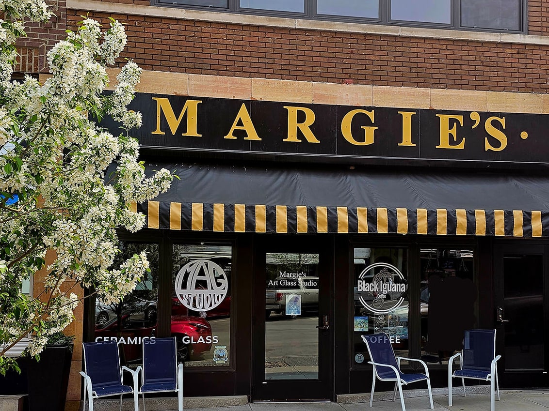 Margie’s storefront in Minot with Art Glass Studio and Black Iguana Coffee window marks
