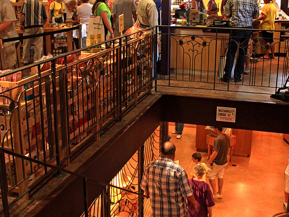 Visitors move between the National Mustard Museum exhibits and the upstairs mustard shop in Middleton