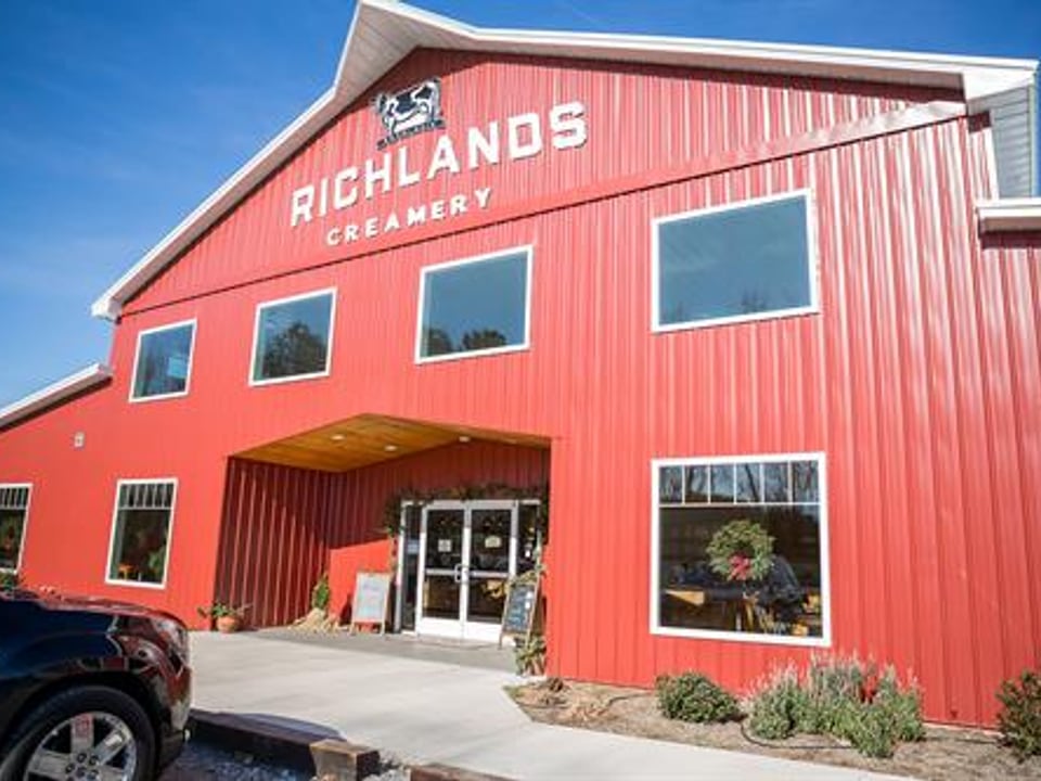 Signed red Richlands Creamery building at the 460 Cox Road dairy property