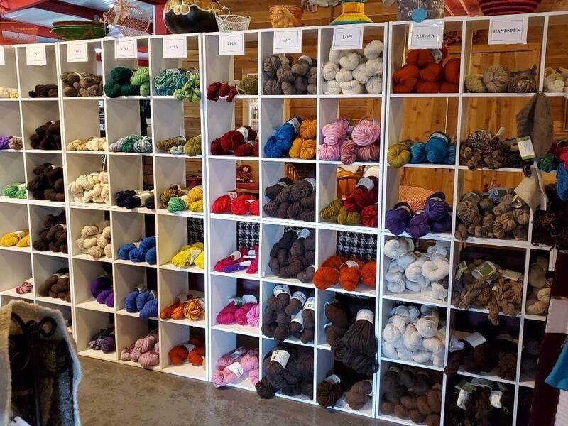 Shelves of colorful yarn and wool inside the Shepherd’s Cross Farm Store