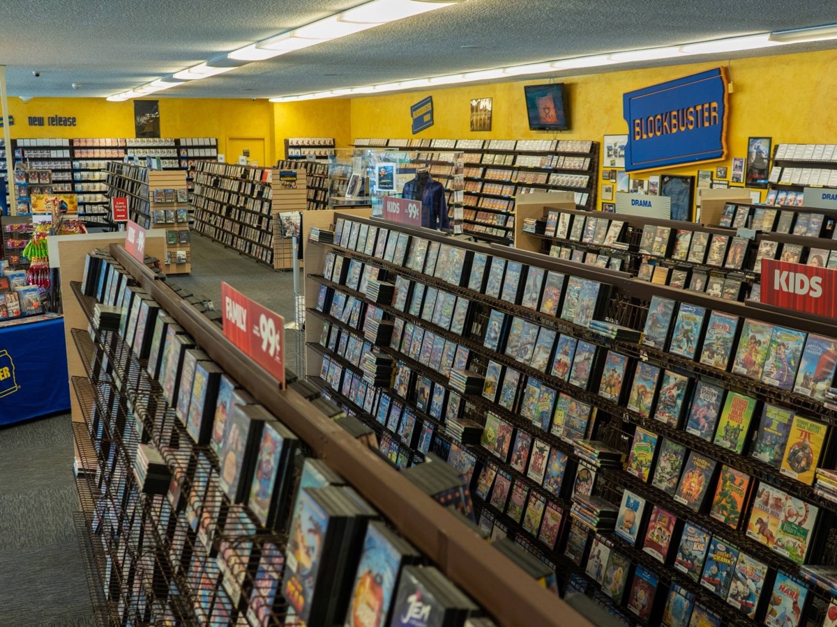 Rows of DVD rentals, classic yellow walls and Blockbuster signs inside the operating Bend store