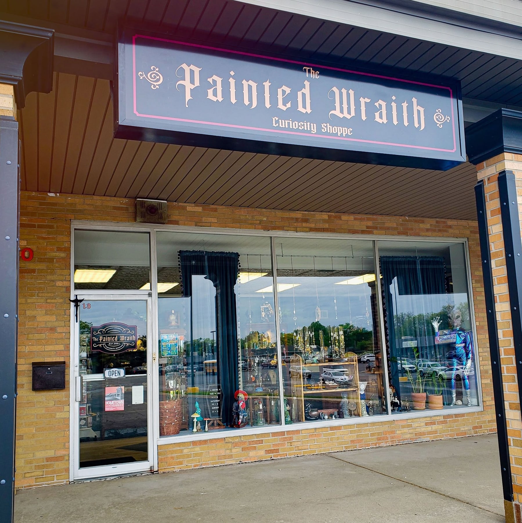 The Painted Wraith Curiosity Shoppe exterior at Towanda Plaza Suite 13 with its signed storefront and display windows