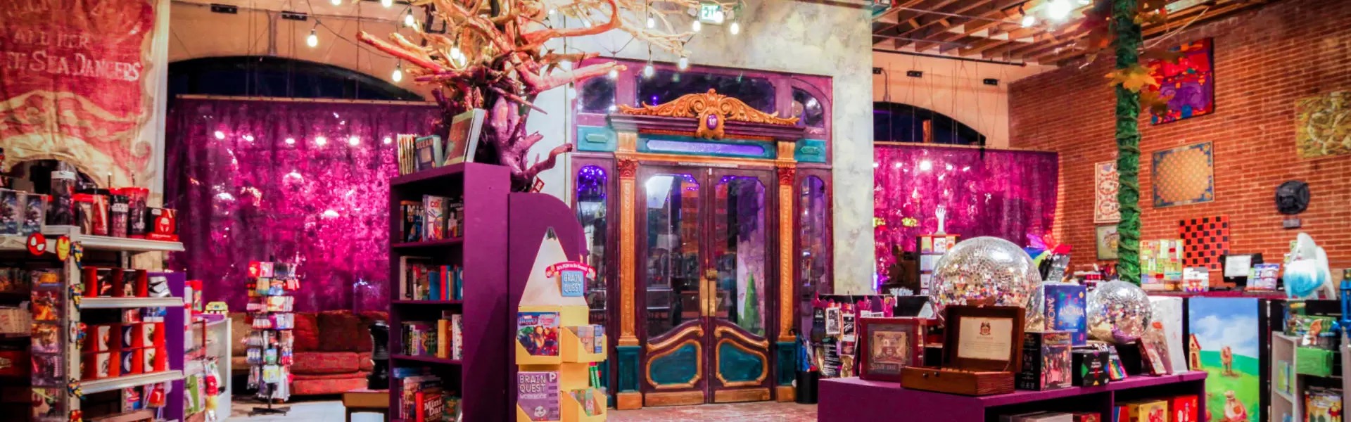 Wide interior of The Wizard's Chest showing its colorful fantasy-themed retail environment