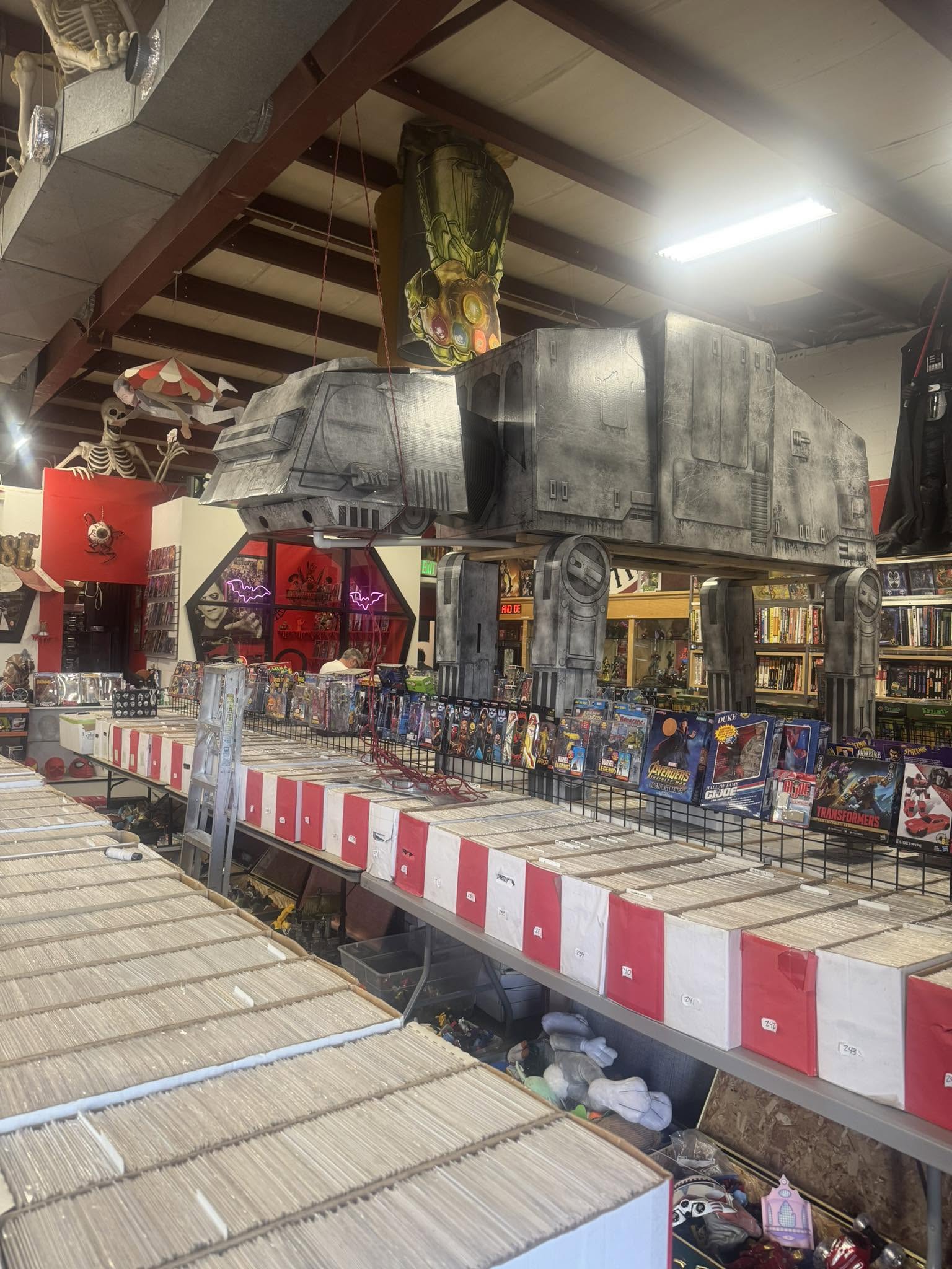 Interior of the new Littleton Vision Comics & Oddities with comic bins, horror displays, and a large AT-AT