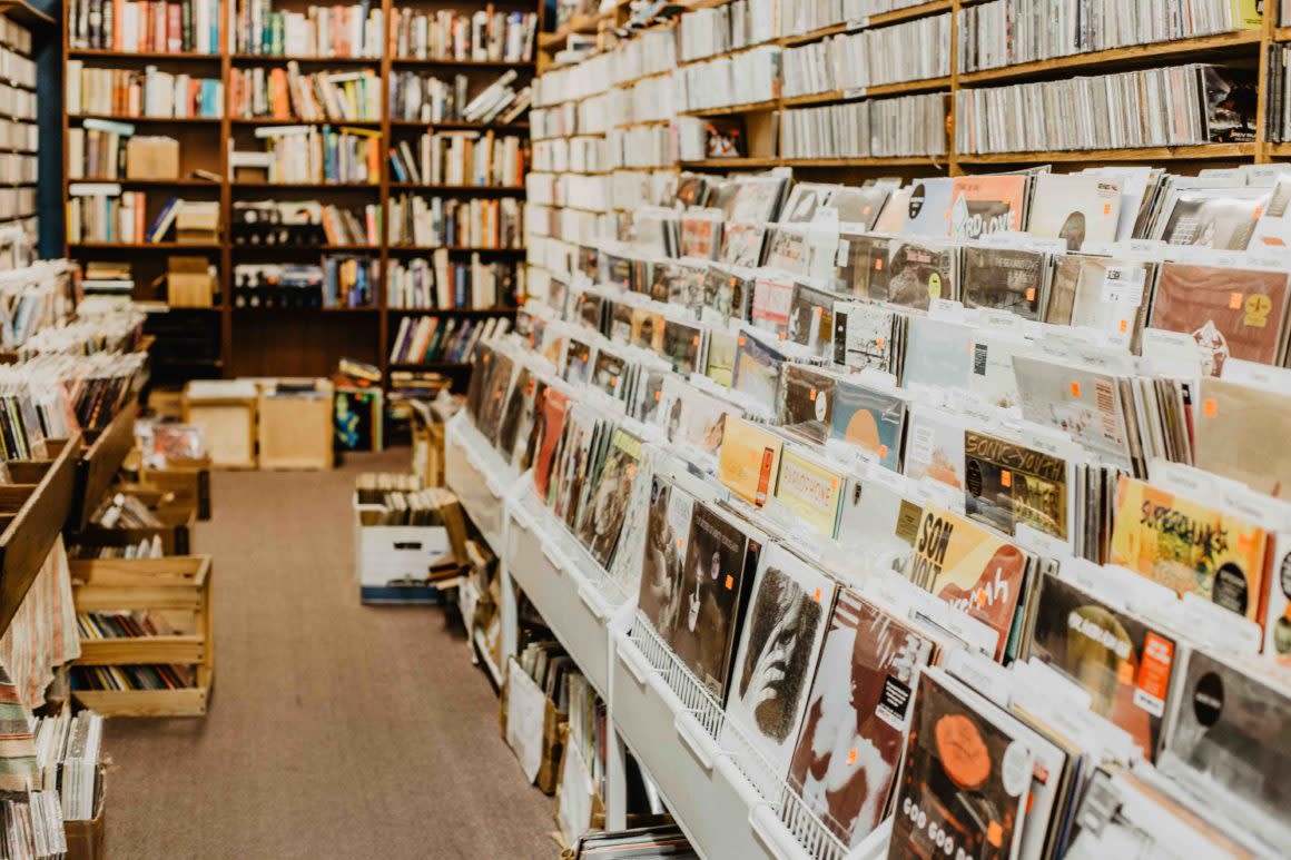 Von's Shops interior with rows of vinyl records beside floor-to-ceiling bookshelves