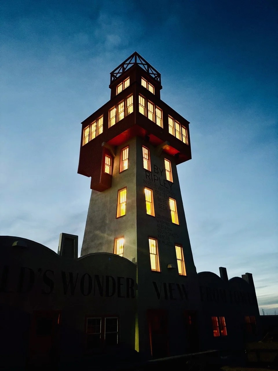 Restored World's Wonder View Tower illuminated at dusk on the eastern Colorado plains